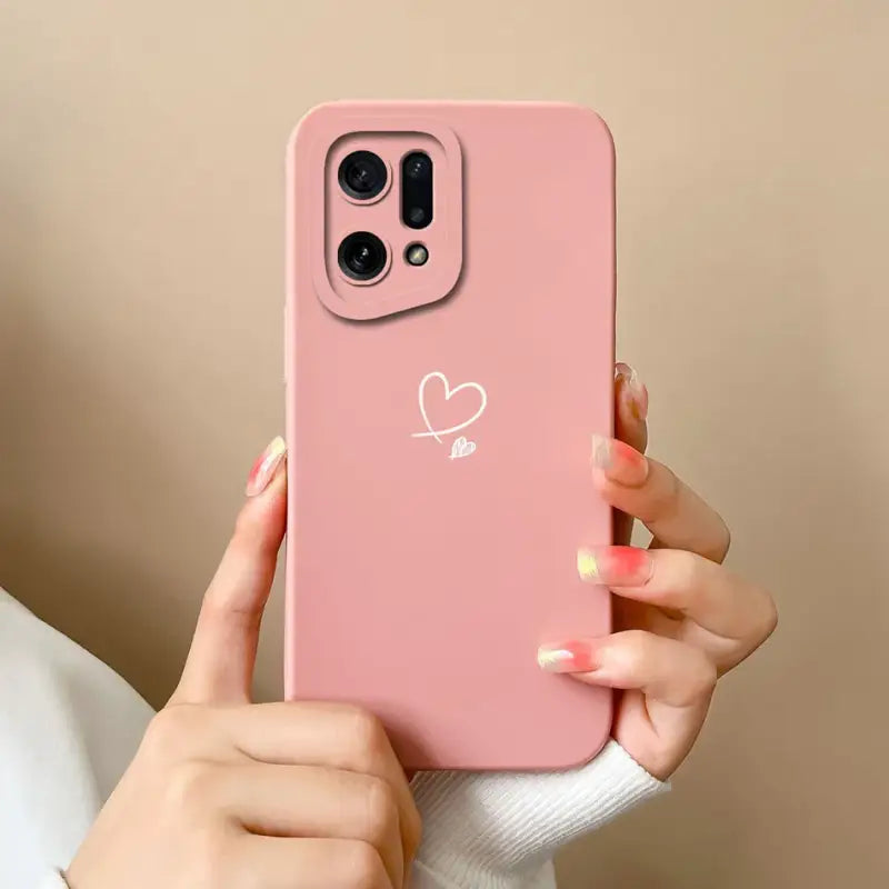 A woman holding a pink phone case with a heart on it