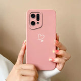 a woman holding a pink phone case with a heart on it