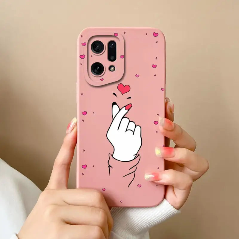 a woman holding a pink phone case with a heart on it