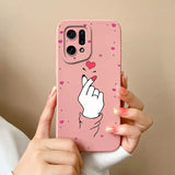 A woman holding a pink phone case with a heart on it