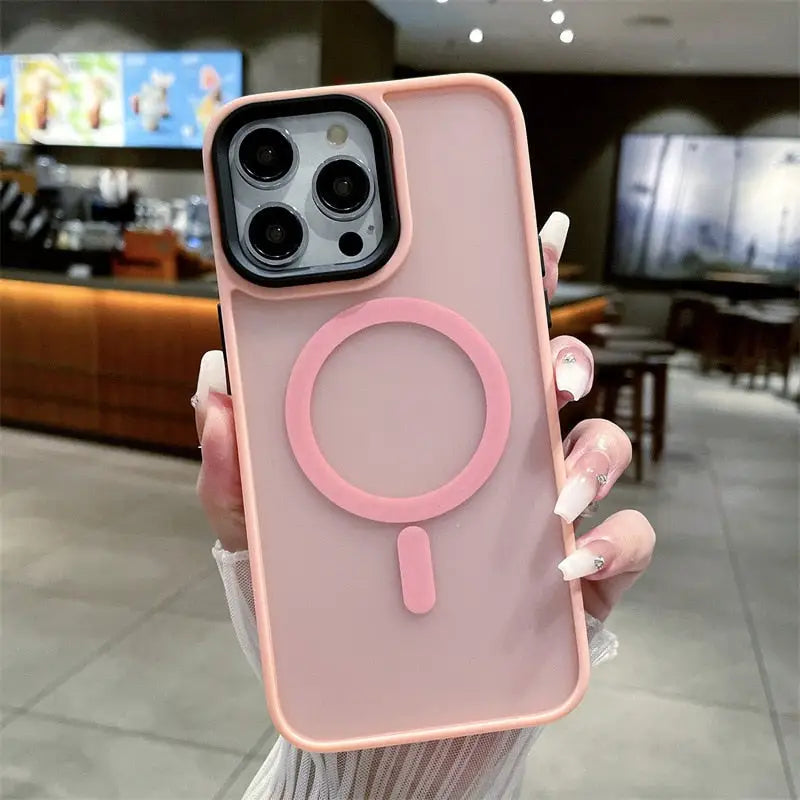 a woman holding a pink phone case with a magni