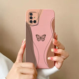 a woman holding a pink phone case with a butterfly on it