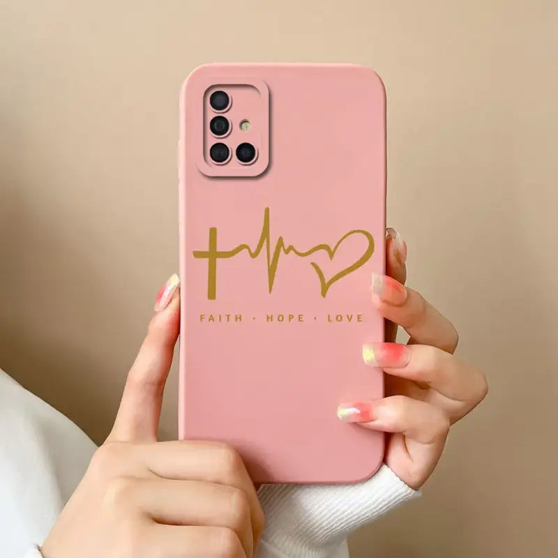 a woman holding a pink phone case with the word faith on it