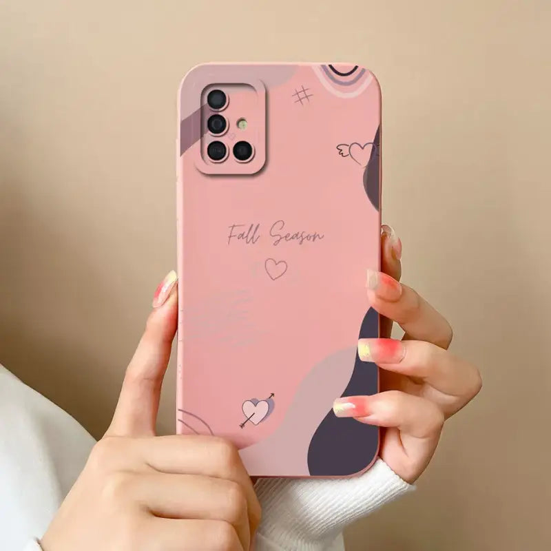 a woman holding a pink phone case with a heart design