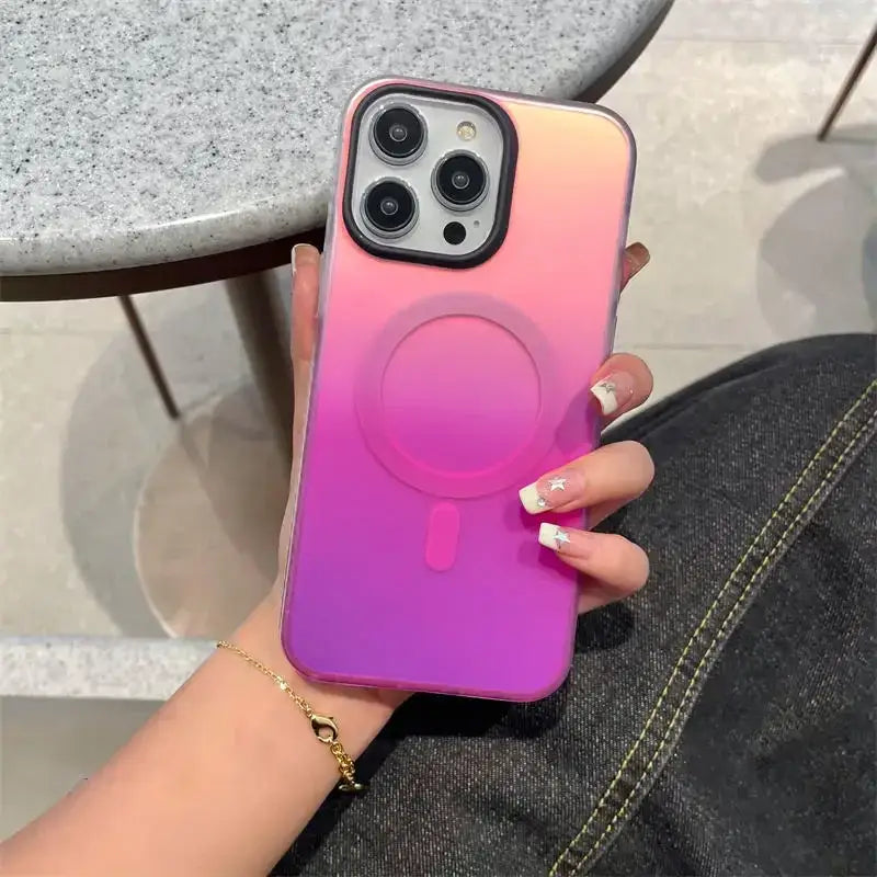 a woman holding a pink and purple phone case