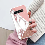 a woman holding a pink and white marble phone case