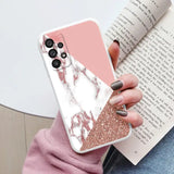 a woman holding a pink and white marble phone case
