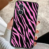 a woman holding a pink zebra print phone case