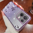 a woman holding a purple glitter phone case