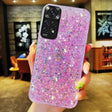 A woman holding a purple glitter phone case