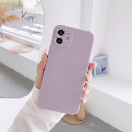 A woman holding a purple iphone case