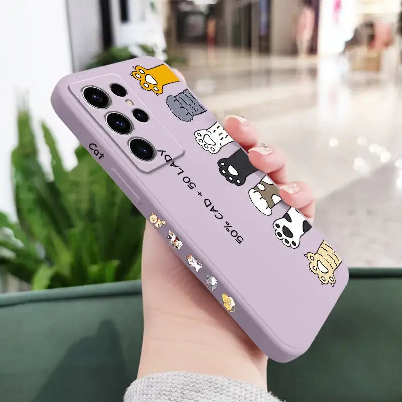 A woman holding a purple phone case with cartoon characters on it