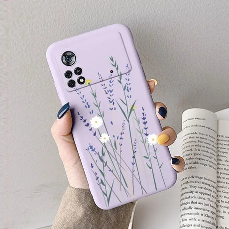 A woman holding a purple phone case with lavender flowers