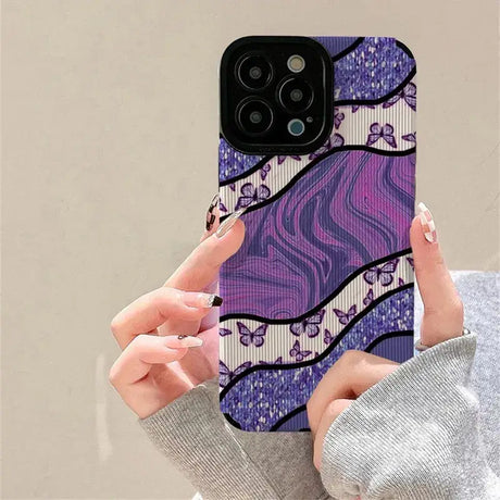 A woman holding a purple phone case