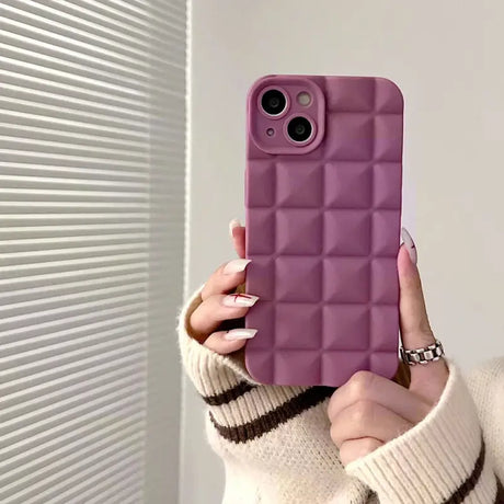 A woman holding up a purple phone case