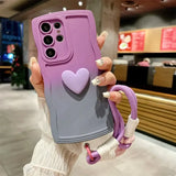 A woman holding up a purple phone case