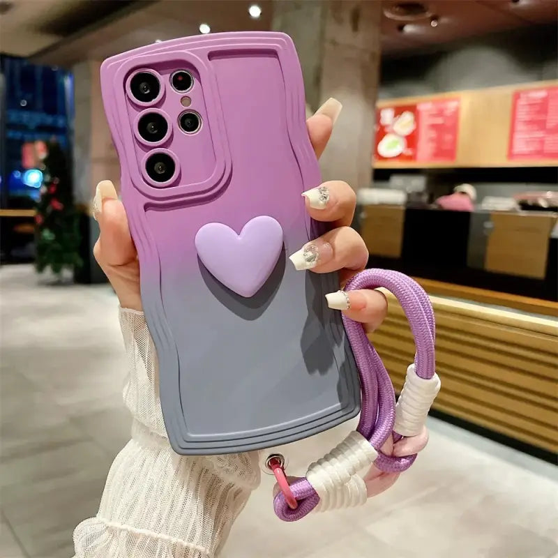 a woman holding up a purple phone case