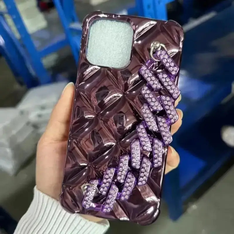a woman holding a purple phone case with purple crystals