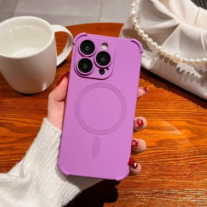 a woman holding a purple phone case