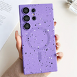 A woman holding a purple phone case with a purple galaxy pattern