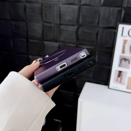 a woman holding a purple phone case