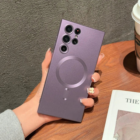 a woman holding a purple phone case