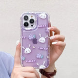 a woman holding a purple phone case with a pattern of rabbits