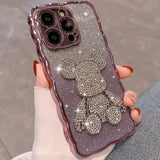 a woman holding a purple phone case with a bow