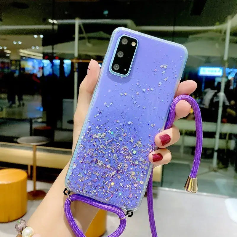 a woman holding a purple phone case with glitter