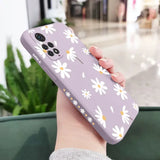 a woman holding a purple phone case with white flowers on it