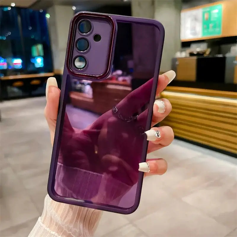 a woman holding up a purple phone case