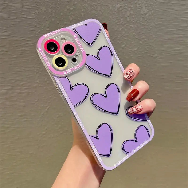 A woman holding a purple phone case with hearts on it