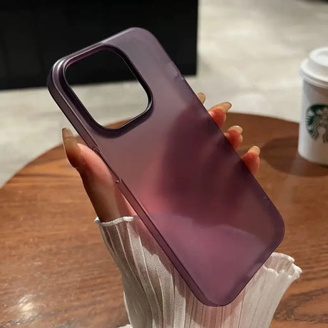 A woman holding a purple phone case