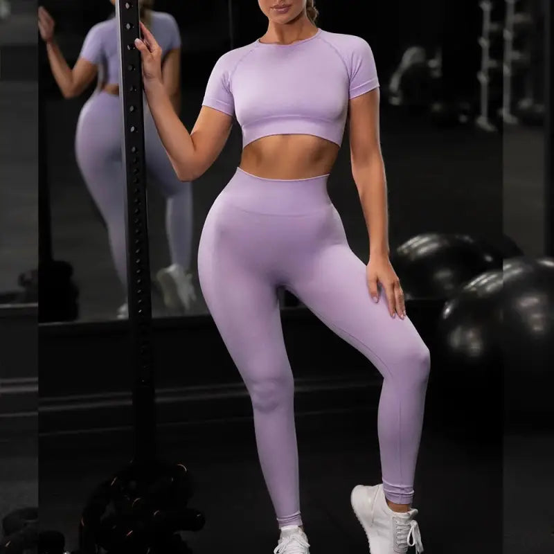 a woman in a purple outfit and white sneakers