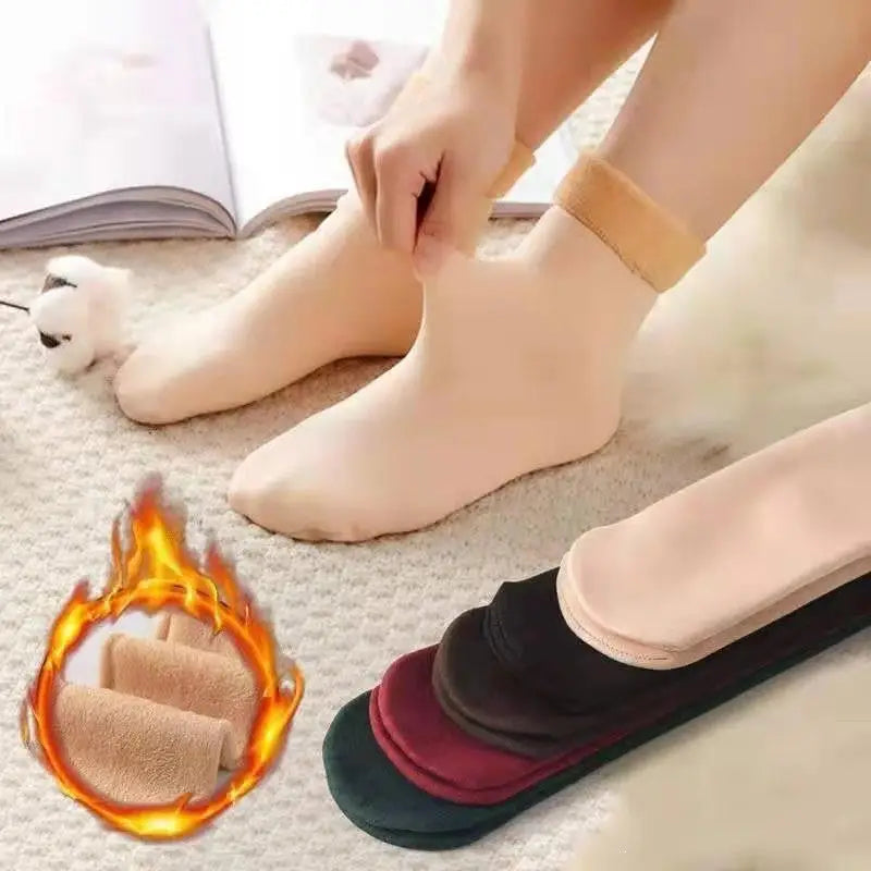 a woman is putting her feet with a pair of socks