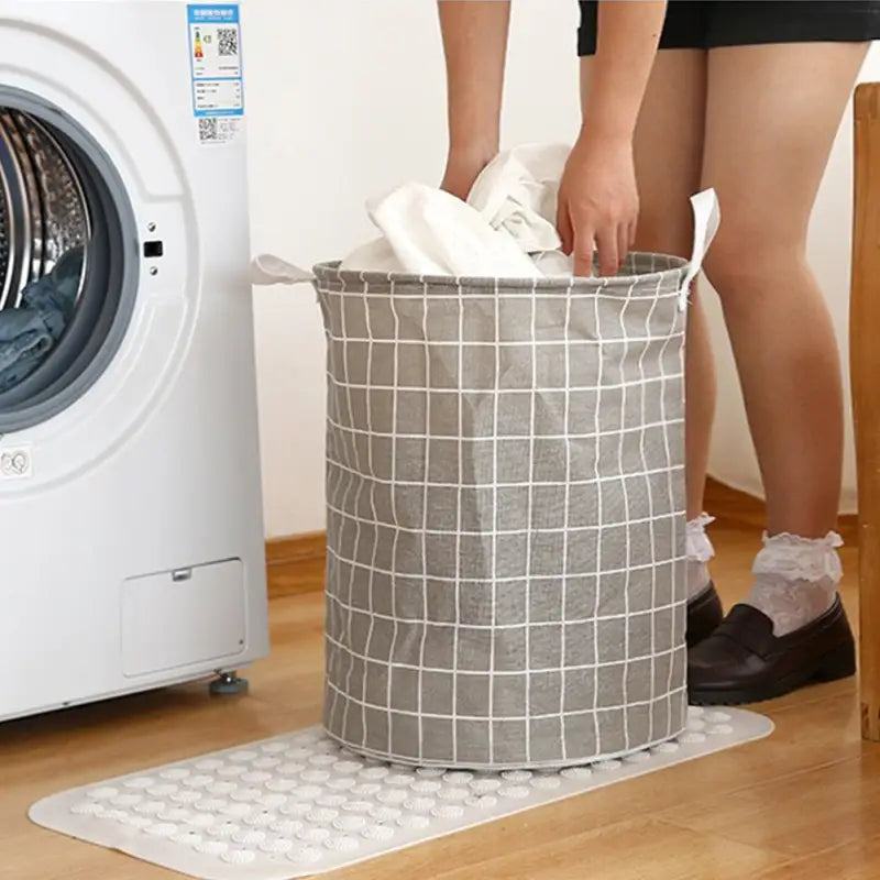 a woman is putting a laundry bag into a washing machine