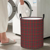 a woman putting a laundry bag in front of a washing machine