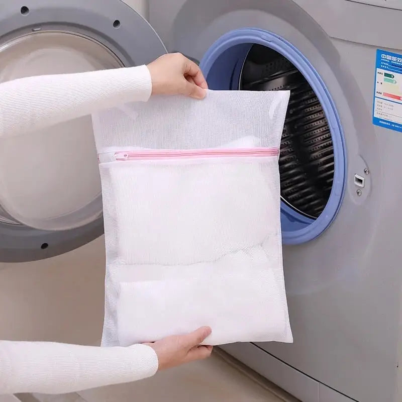 a person putting a bag of toilet paper into a washing machine