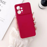 a woman holding a red iphone case