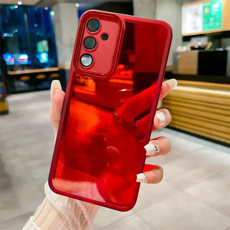 a woman holding a red iphone case