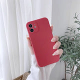 A woman holding a red iphone case