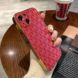 a woman holding a red phone case