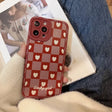 A woman holding a red and white iphone case