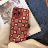 a woman holding a red and white iphone case