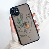 a woman’s face with leaves on a phone case