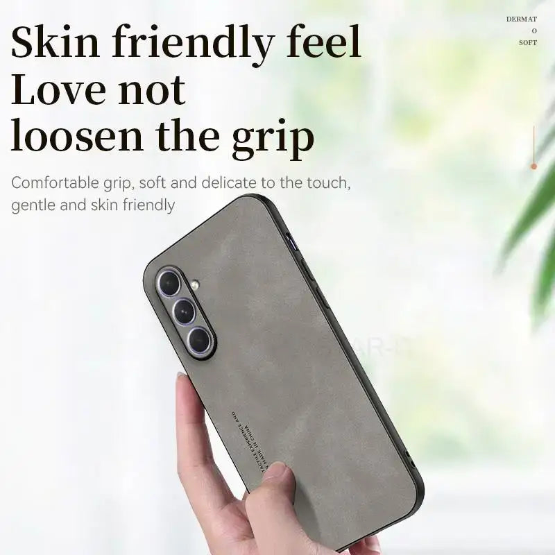the back of a woman’s hand holding a gray iphone case