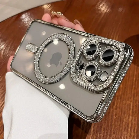 A woman holding a silver iphone case with a camera