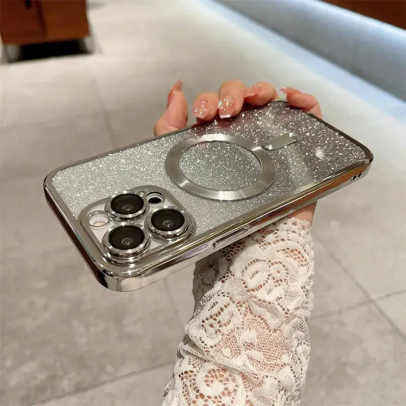 a woman holding a silver phone case with two silver rings