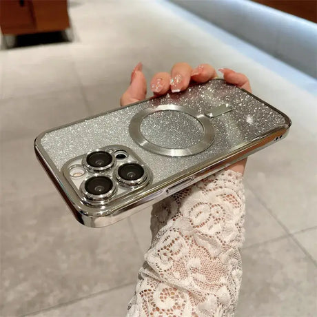 A woman holding a silver phone case with two silver rings