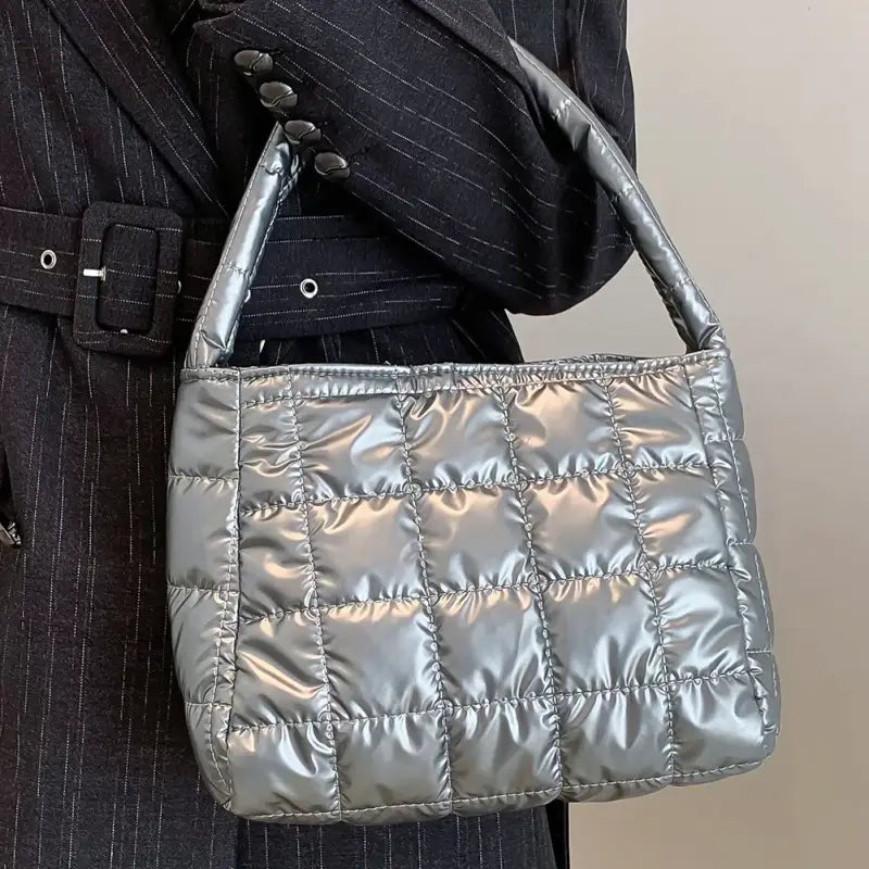 a woman holding a silver purse